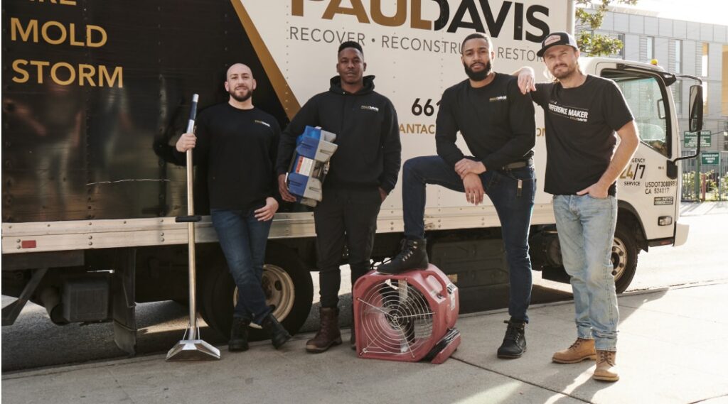 Paul Davis Restoration of Central DFW emergency response team standing beside a restoration truck with water damage drying equipment and cleanup tools in Dallas-Fort Worth.